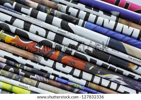 close up on a pile of differnt color newspaper titles Royalty-Free Stock Photo #127832336