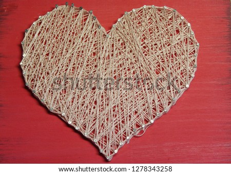 pink heart of thread on a red wooden Board. techniques String art handmade gift for Valentine's day. flatlay. with love. Royalty-Free Stock Photo #1278343258