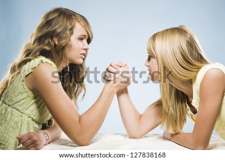 Two girls arm wrestling