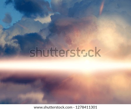 Amazing sunset picture with fluffy clouds, against sun rays reflected on the water surface.