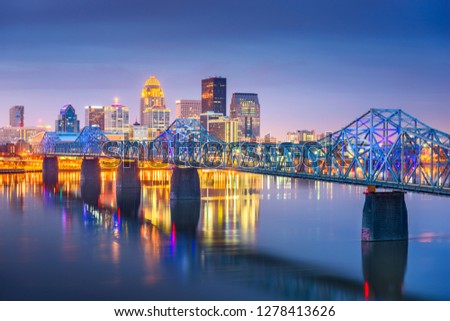 Louisville, Kentucky, USA downtown skyline on the Ohio River at dusk. Royalty-Free Stock Photo #1278413626