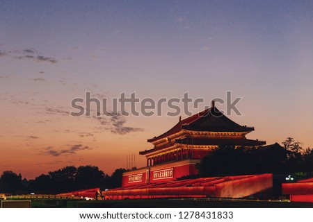 Tiananmen Gate of Forbidden City at sunset with blue and orange sky, in Beijing, China, with placards "Long Live the People's Republic of China and the Great Unity of the World's Peoples" Royalty-Free Stock Photo #1278431833