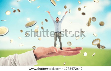 Big hand holds a businessman that achieves the success