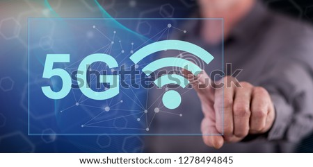 Man touching a 5g concept on a touch screen with his finger Royalty-Free Stock Photo #1278494845