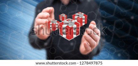 Gift concept between hands of a man in background