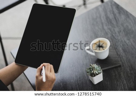 Mock up of a woman holding digital tablet device in hands with digital pencil. Tablet and digital pen connecting wifi. Copy space. - Image