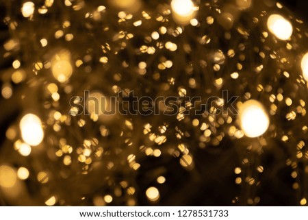 Gold yellow light abstract bokeh on black background