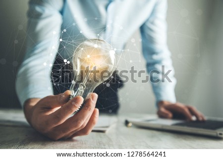 man hand light lulb with network in ofice