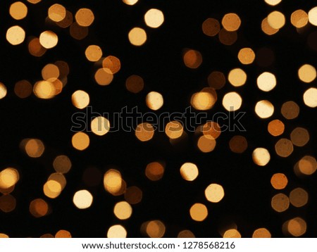 Abstract blurred bokeh background. Christmas, New Year, holiday blurred background. Warm light blurred background.