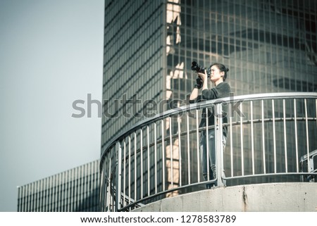 Woman photographer taking photo in urban city
