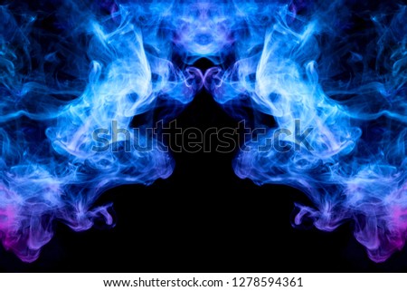 Dense multicolored smoke of   blue and purple colors in the form of a skull, monster, dragon on a black isolated background. Background of smoke vape. Mocap for cool t-shirts
