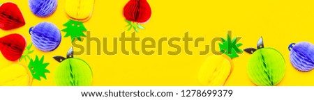 Flat lay bright tropical fruits of paper, strawberry, pineapple, apple, plum on yellow background top view copy space. Minimalistic creative summer food concept, origami paper fruit 
