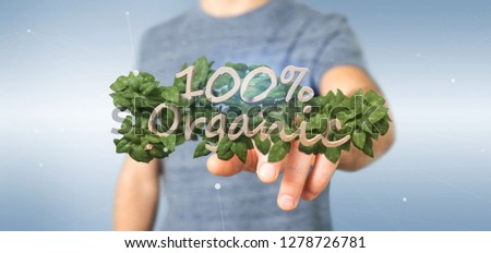 View of a Businessman holding a Wooden logo 100 % organic with leaves around 3d rendering
