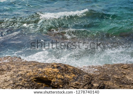 Photo of Waves breaking on a stony beach in Murter, Croatia, Dalmatia