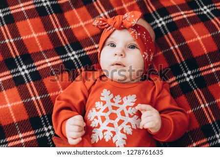 Little girl lying on a blanket. New year photo