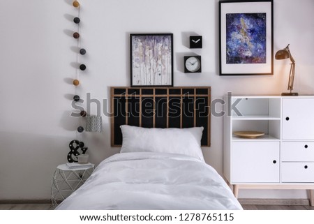 Modern teenager room interior with comfortable bed