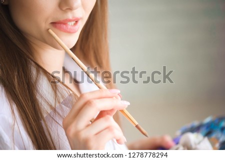Close up view of female artist painting picture