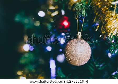 Christmas tree decorations and baubles with golden tones shot at shallow depth of field