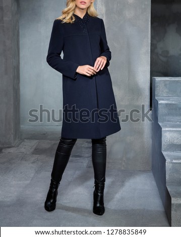 Fashion woman is wearing winter coat and clothes. Beautiful studio decor, great poses. Outerwear in different colors. Fur, pattern, red, green, burgundy, cream and different colors. 