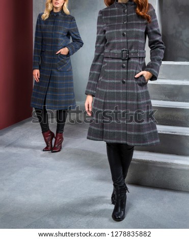 Fashion woman is wearing winter coat and clothes. Beautiful studio decor, great poses. Outerwear in different colors. Fur, pattern, red, green, burgundy, cream and different colors. 