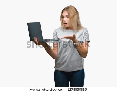 Young caucasian woman using computer laptop over isolated background very happy pointing with hand and finger