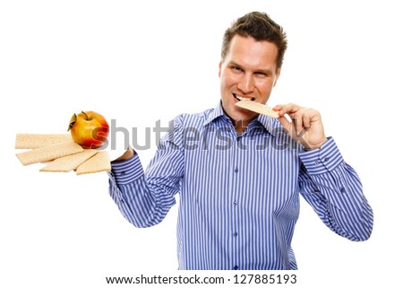Man eating healthy in her diet, having a crispbread and apple studio shot white background