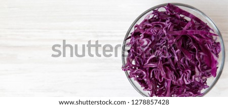 Chopped red cabbage in a bowl, overhead view. Top view, from above, flat lay. Copy space.