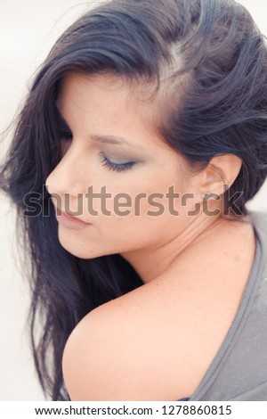 Portrait of black haired woman outside
