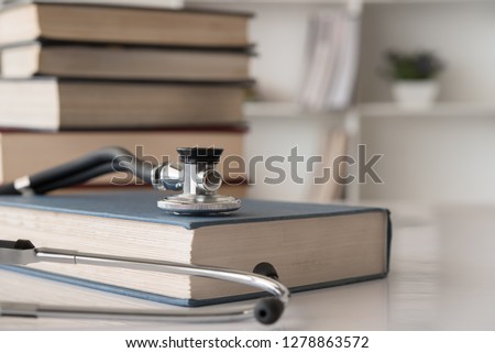 stethoscope on medical guide book for doctor learning treatment at hospital.  medical education learning concept. Royalty-Free Stock Photo #1278863572