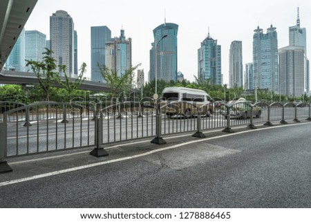 cityscape and skyline of shanghai from empty asphalt road
