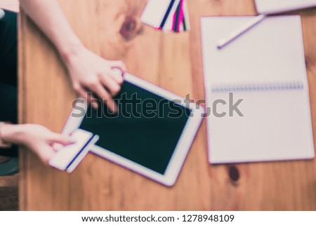 blur photo,The girl sat by the window of the house in the morning and was paying with a credit card to shop online via her tablet and enjoyed online shopping.
Convenience concept with Online shopping