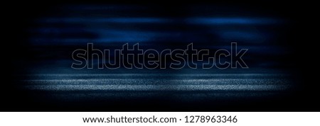 The background of wet asphalt, the reflection of the night lights of the city, neon light, smoke. Abstract empty dark blue scene