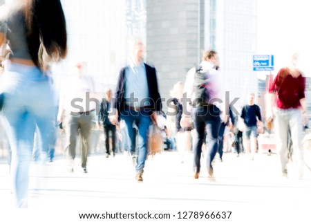 London, UK. Blurred image of office workers crossing the London bridge in early morning on the way to the City of London