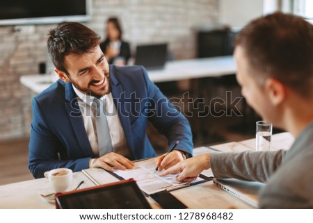 Two businessman make a deal and signing a contract
