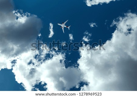 The plane against the blue sky and fluffy clouds. Concept of vacation, vacation, flight, travel.