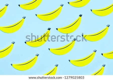 Creative summer pattern bright sweet tropical banana of paper on blue background Flat lay top view copy space. Minimalistic food concept, origami paper fruit. Banana background