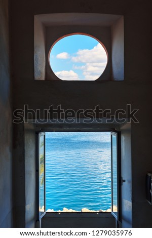 View of the sea and sky through the window. Porto Santo Stefano in Monte Argentario. Tuscany. Italy