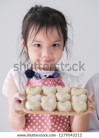 Girl showing her homemade bread or donut, lifestyle concept.