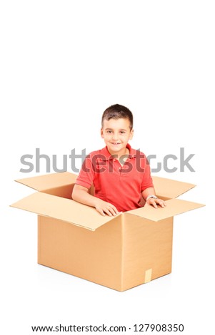 A smiling child in a cardbox isolated against white background