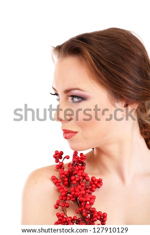 Beautiful young woman with bright make-up, holding branch with red berries, isolated on white