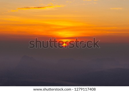 Natural Sunset Sunrise Over Field Or Meadow. Bright Dramatic Sky And Dark Ground. Countryside Landscape Under Scenic Colorful Sky At Sunset Dawn Sunrise. Sun Over Skyline, Horizon. Warm Colours. 