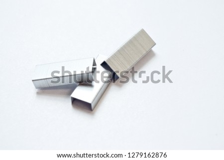 Staples on white background - selective focus -image