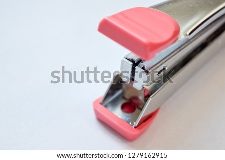 Pink stapler on white background - image