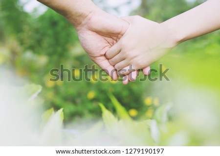 Woman and man holding Shake hands, Happy couple love in the garden. concept couple lover valentine day.	
