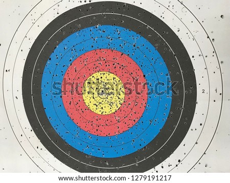 Practice target with a lot of shots. Used archery target set on position on archery range. 