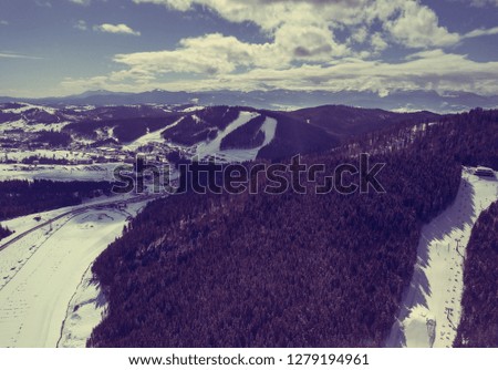Aerial drone landscape photo of Carpathian mountains in cold winter day.Travel destination for active tourism in Europe.Enjoy beauty of nature in Carpathians.Ski and snow board park from above