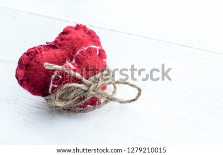 Two decorative hearts on wooden background. Symbol of love.