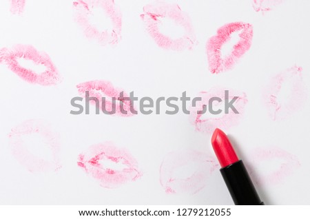 Lipstick kisses and lipstick tube on white background. St. Valentin's day concept. Copy space