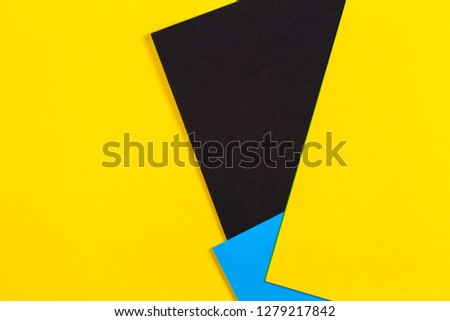 Geometric flat lay yellow blue and black color paper background