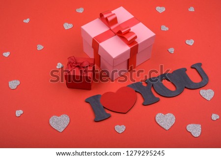 Gift and hearts on red background. Valentines Day.